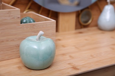 Beautiful ceramic apple on wooden dressing table