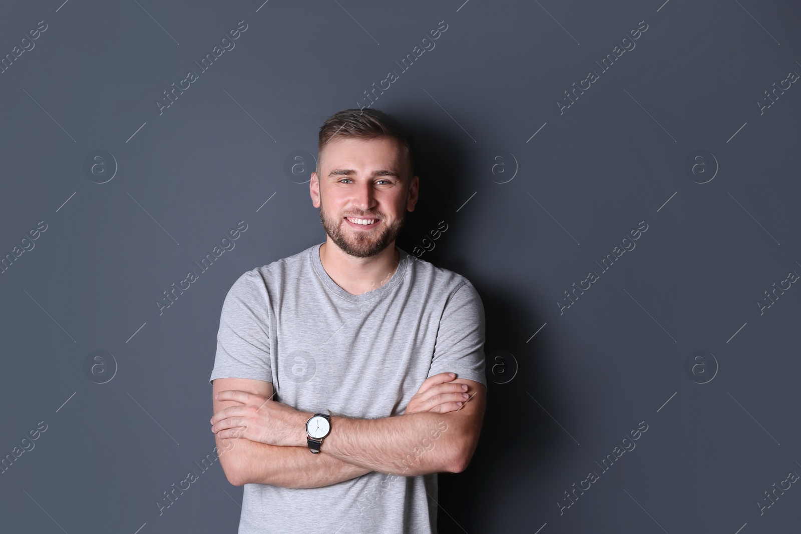 Photo of Portrait of handsome happy man on grey background