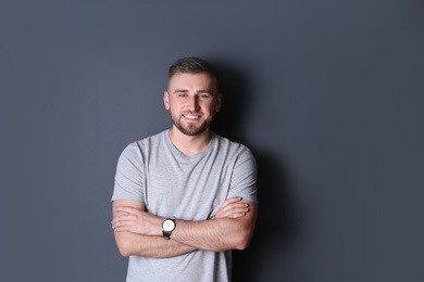 Photo of Portrait of handsome happy man on grey background