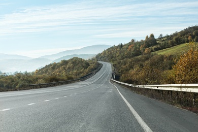 Landscape with asphalt road leading to mountains