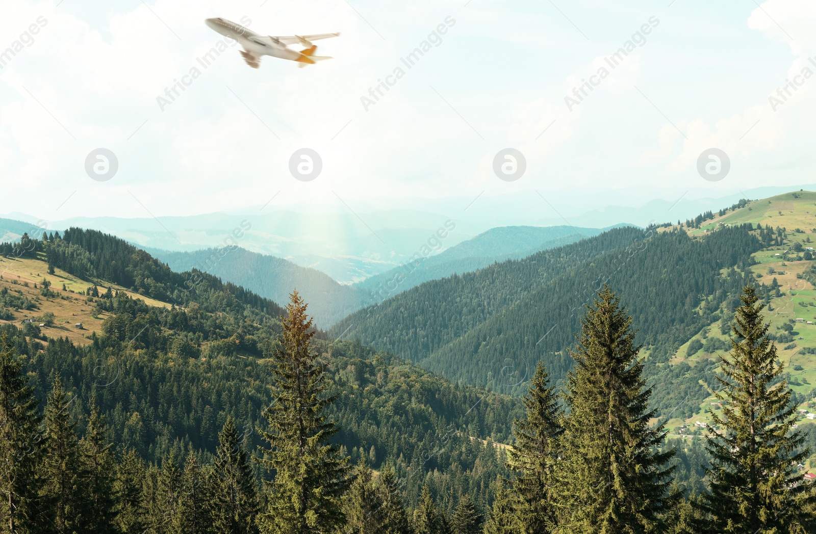 Image of Airplane flying over beautiful mountain slopes. Air travel