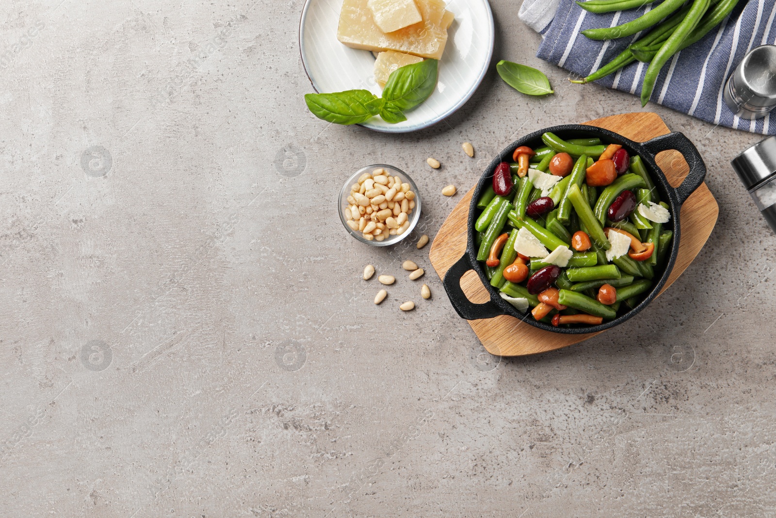 Photo of Delicious salad with green beans, mushrooms and cheese on light grey table, flat lay. Space for text