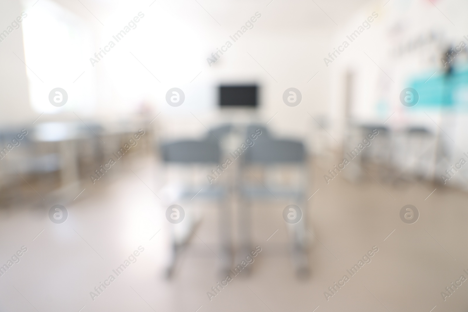 Photo of Blurred view of empty school classroom with desks and chairs