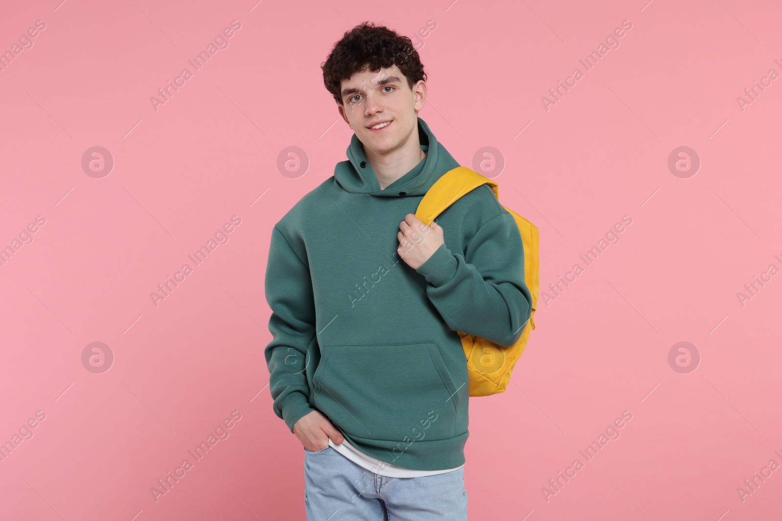 Photo of Portrait of student with backpack on pink background