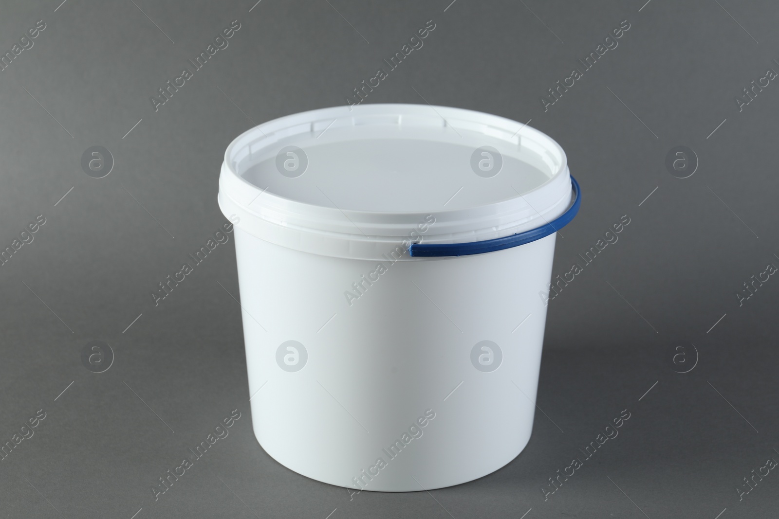 Photo of One plastic bucket with lid on grey background