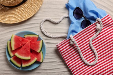 Photo of Flat lay composition with striped beach bag on sand