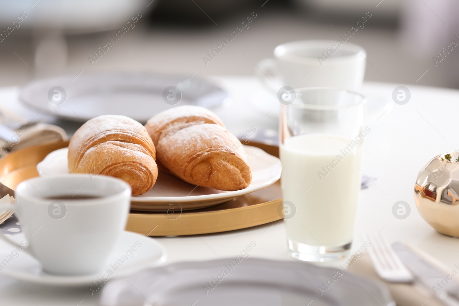 Photo of Tasty breakfast with fresh croissants on table