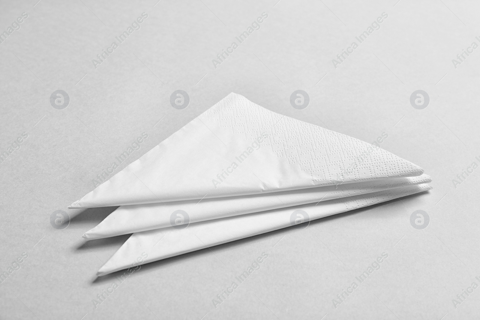 Photo of Clean napkins on grey background. Personal hygiene