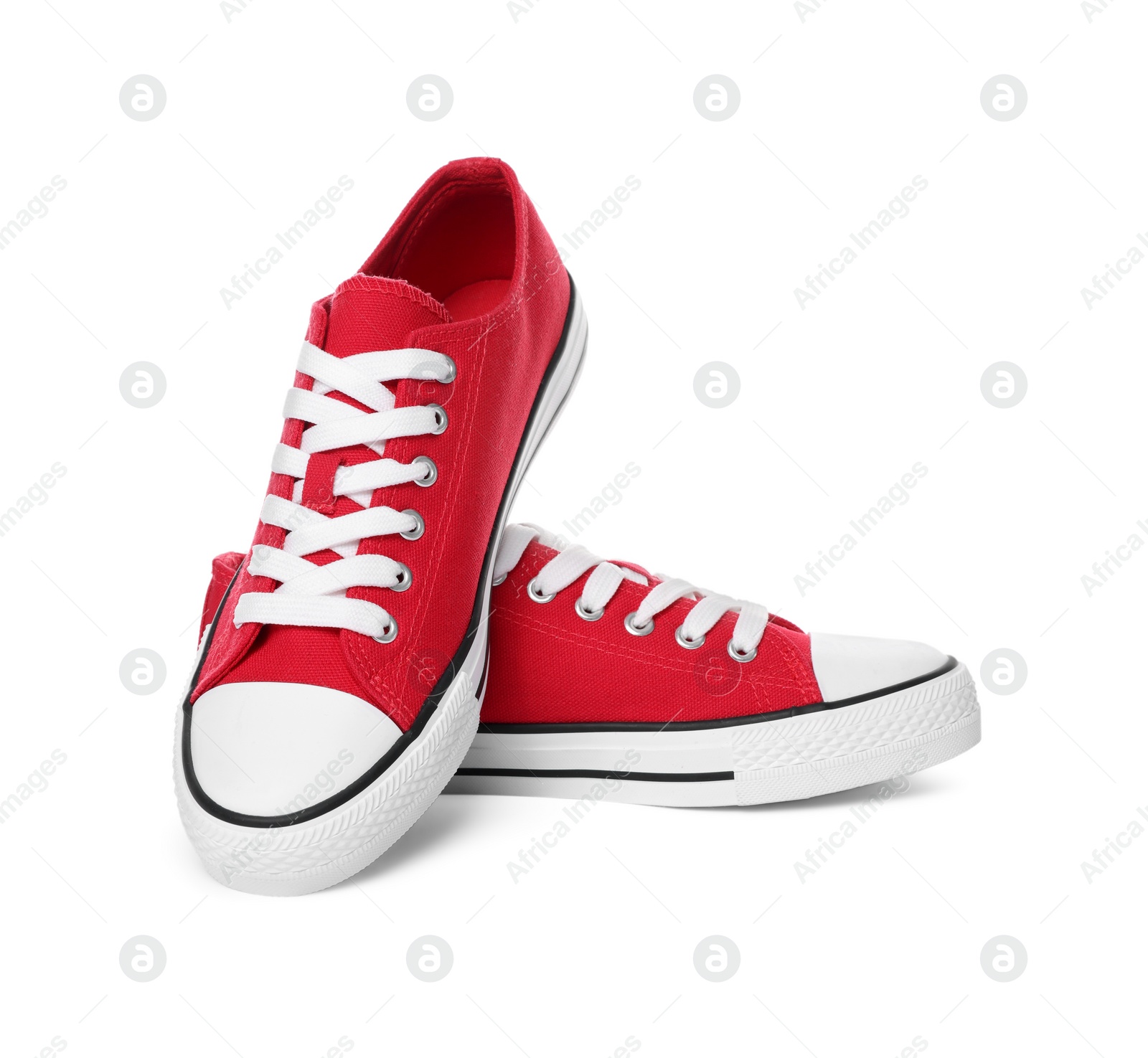 Photo of Pair of red classic old school sneakers on white background