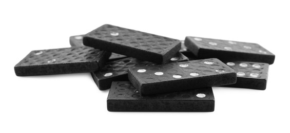 Photo of Pile of black domino tiles on white background