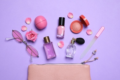 Photo of Flat lay composition with sunglasses and perfumes on violet background
