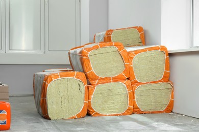 Photo of Stacked packages of thermal insulation material in room