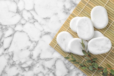 Photo of Flat lay composition with spa stones and leaves on marble table, space for text