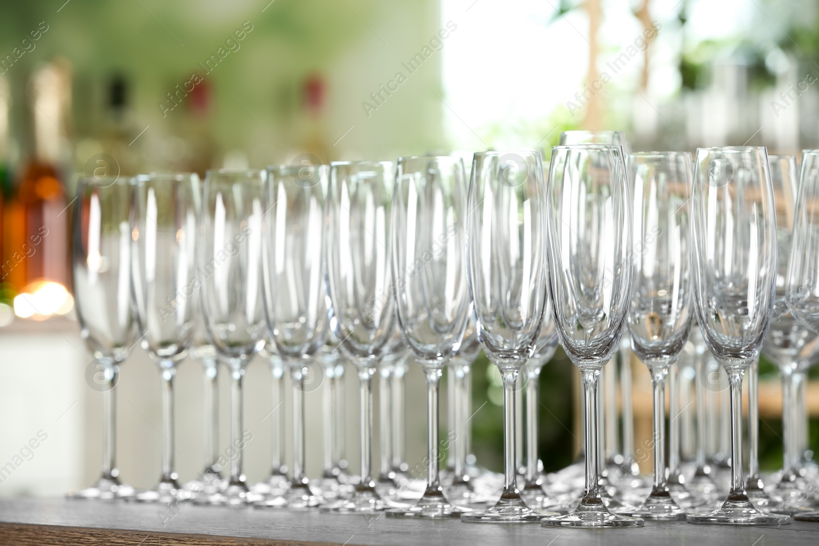 Photo of Empty glasses on wooden table against blurred background