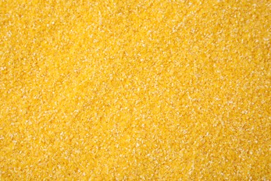 Photo of Raw corn grits as background, top view