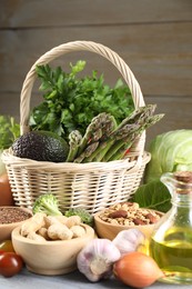 Healthy food. Basket with different fresh products on grey table, closeup