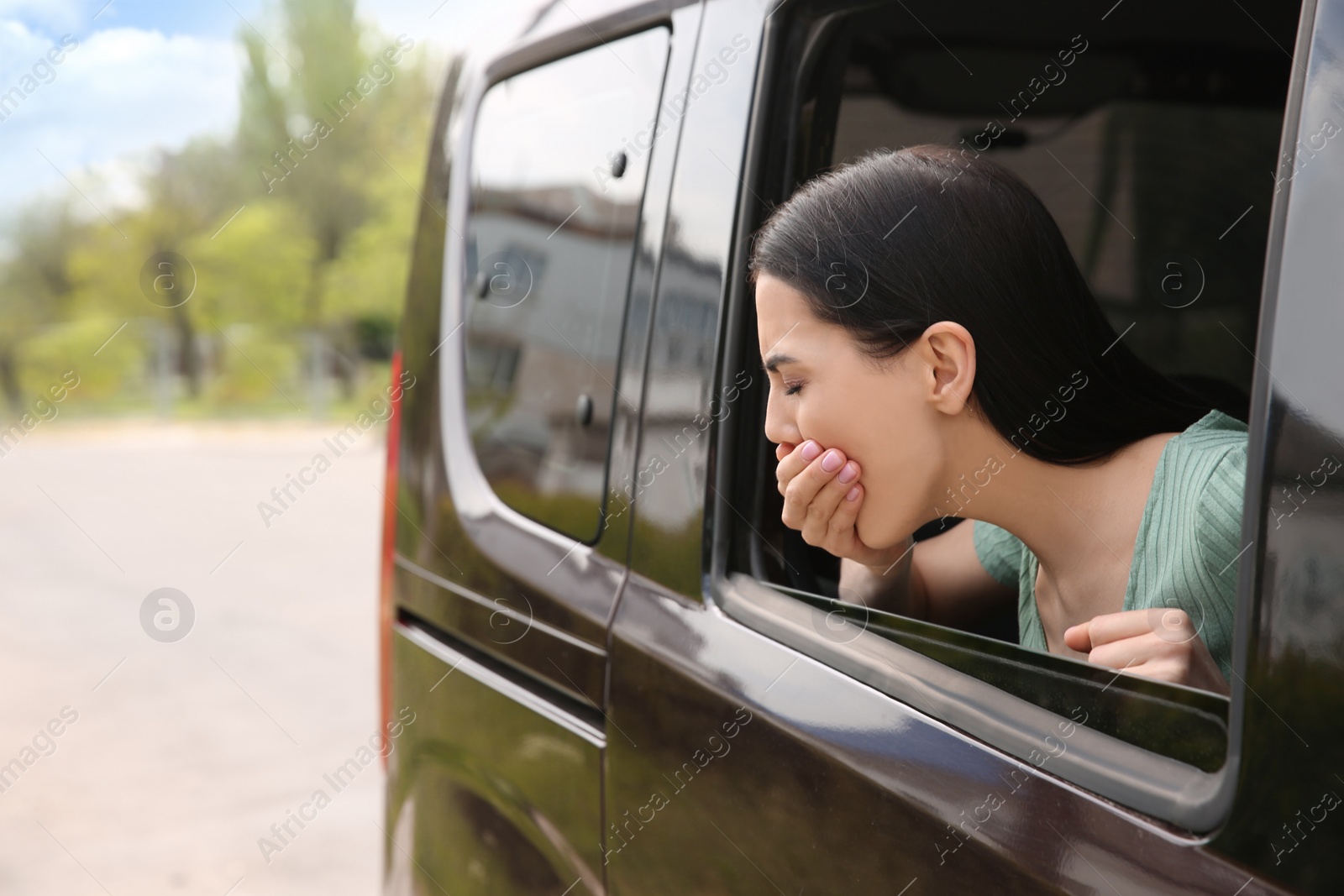 Photo of Young woman suffering from nausea in car