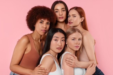 Portrait of beautiful young women on pink background