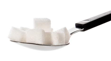 Refined sugar cubes in spoon on white background