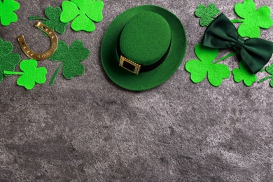 Leprechaun's hat and St. Patrick's day decor on grey stone background, flat lay. Space for text