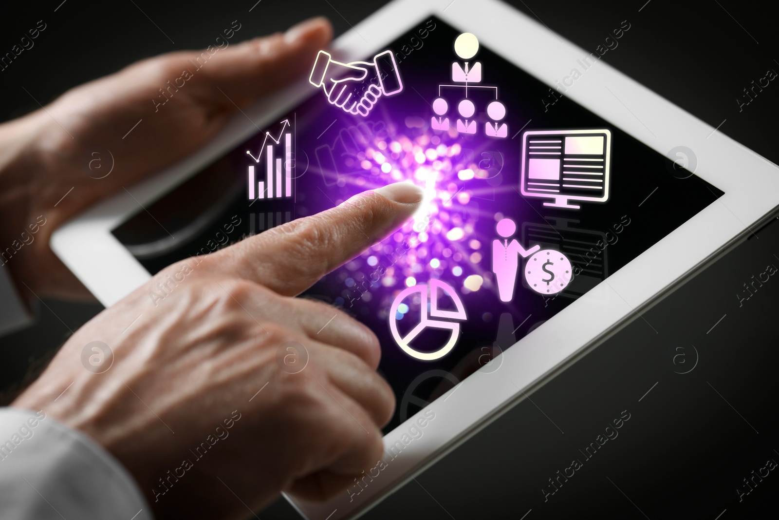 Image of Marketing. Man using tablet against black background, closeup. Virtual icons popping out from device screen