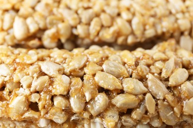 Tasty sunflower seed bars as background, closeup