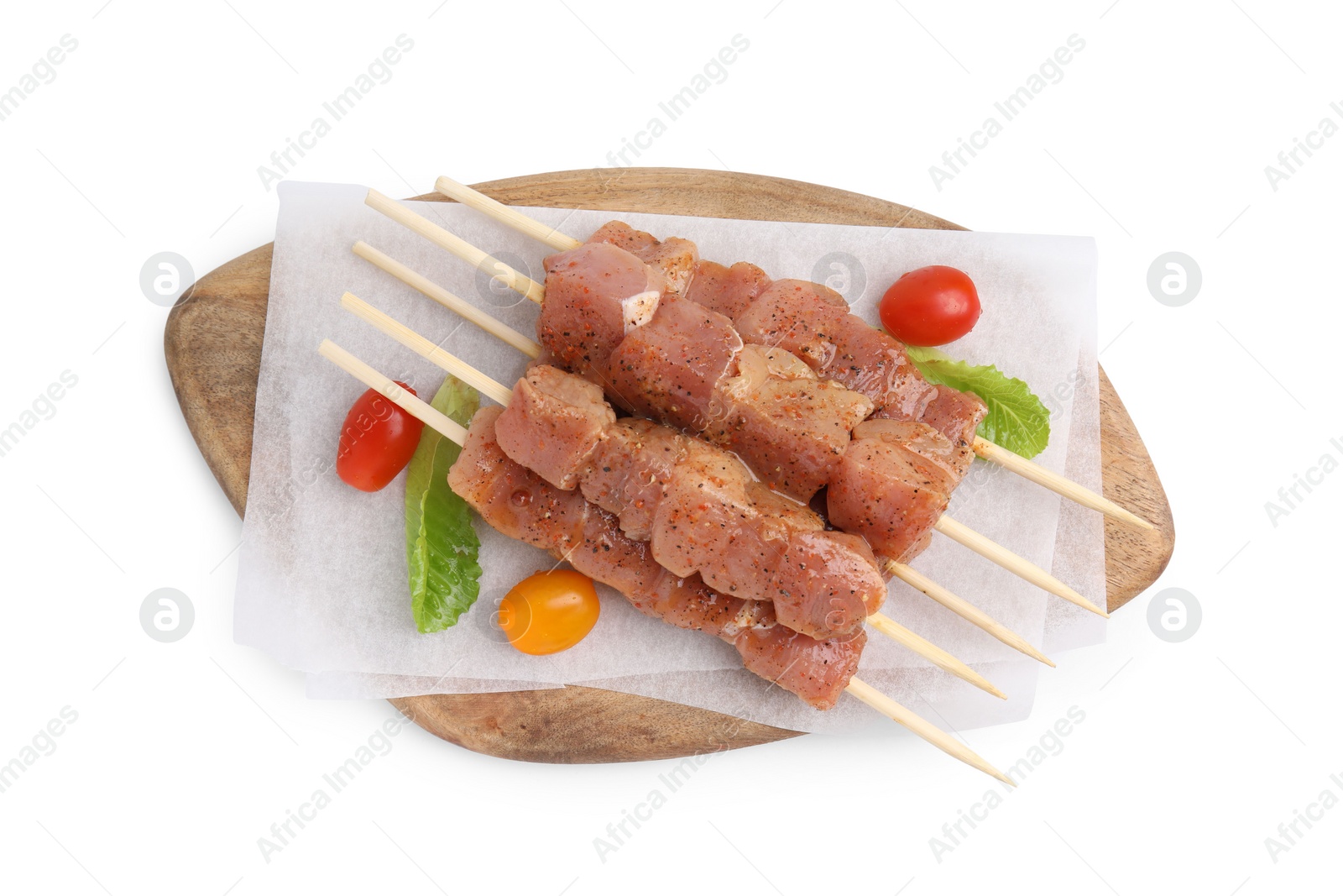 Photo of Wooden skewers with cut raw marinated meat isolated on white, top view