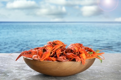 Image of Cooked crayfishes on grey table near sea