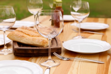 Photo of Set of dishware on table outdoors. Summer picnic
