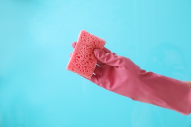 Photo of Woman cleaning glass against color background