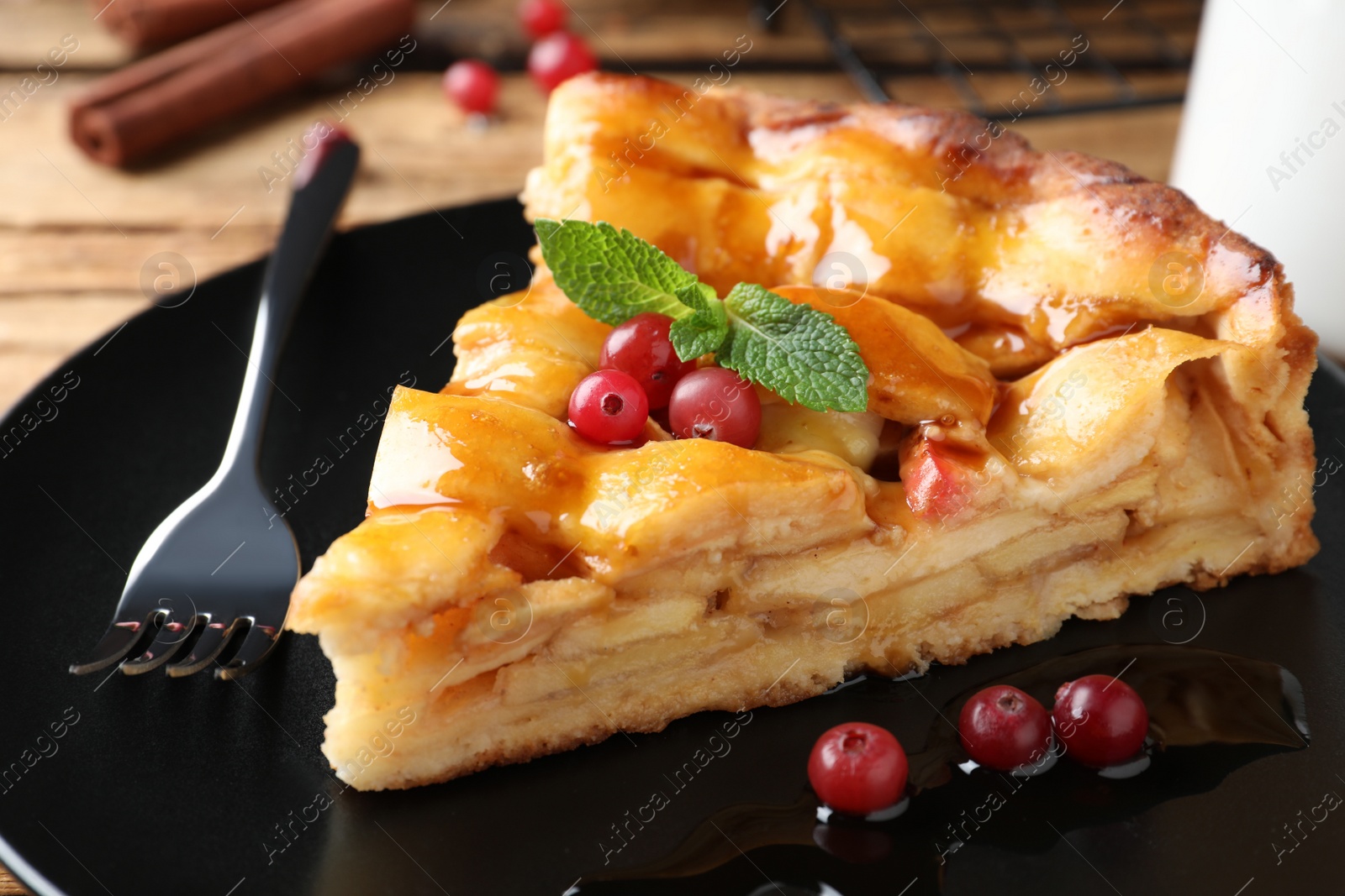 Photo of Slice of traditional apple pie with berries on plate, closeup