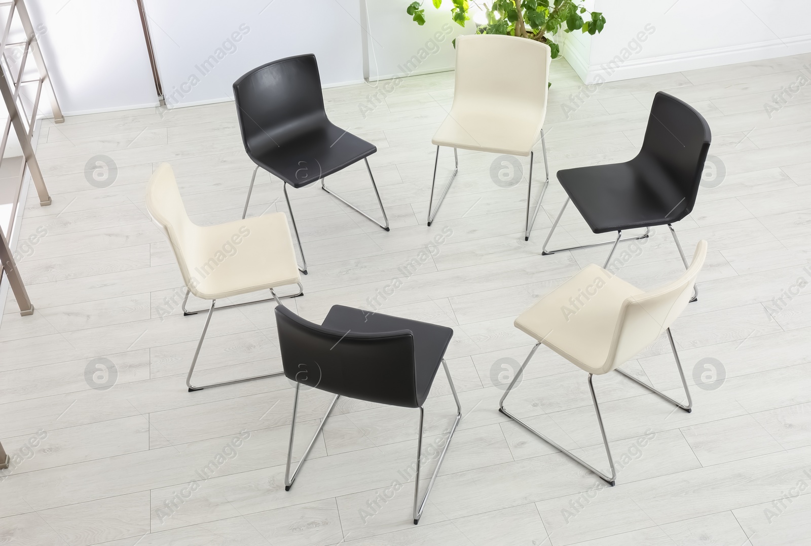 Photo of Empty chairs prepared for group psychotherapy session indoors