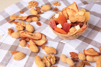 Photo of Mixed dried fruits and nuts on checkered tablecloth