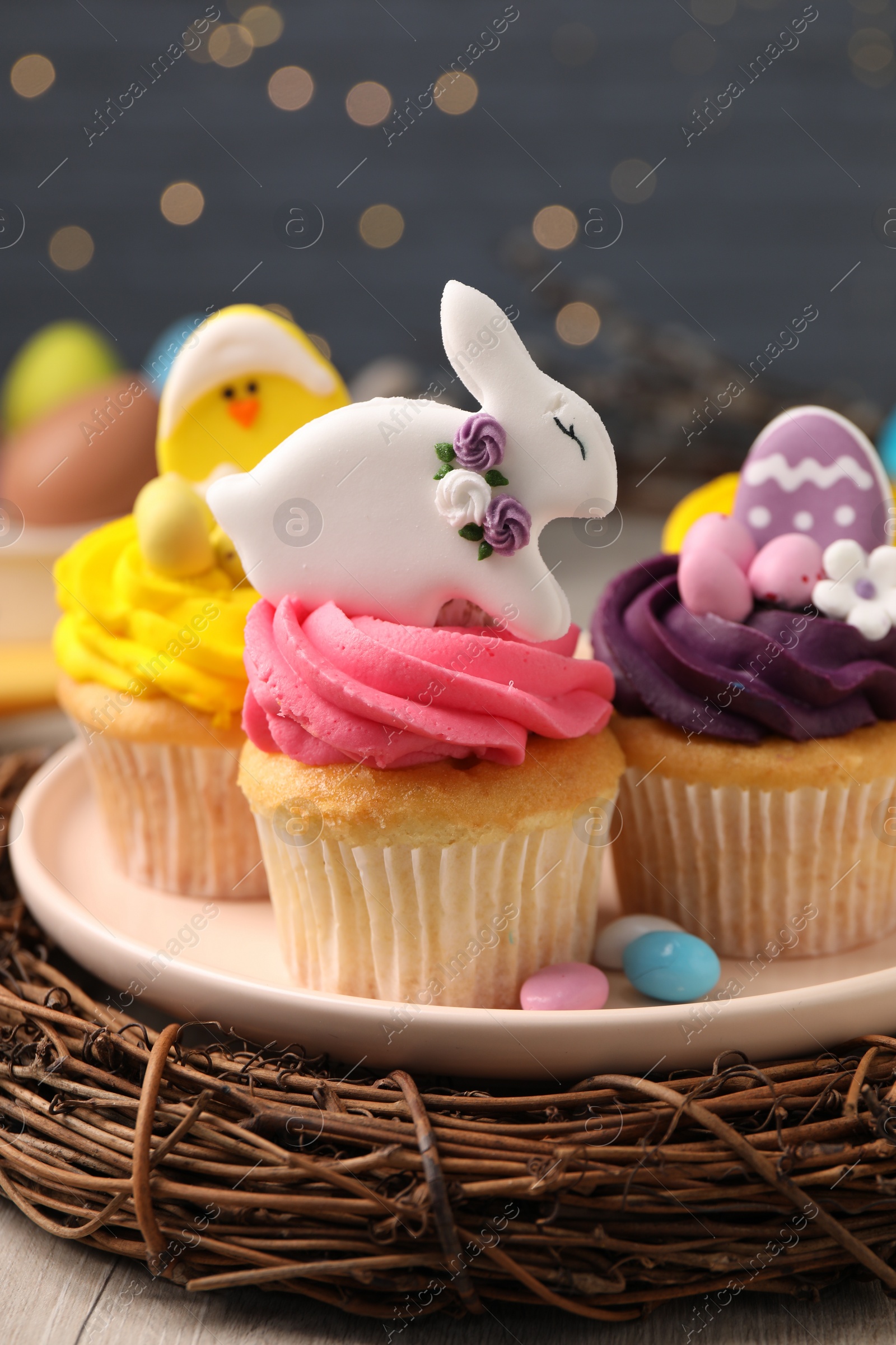 Photo of Tasty decorated Easter cupcakes on wooden table