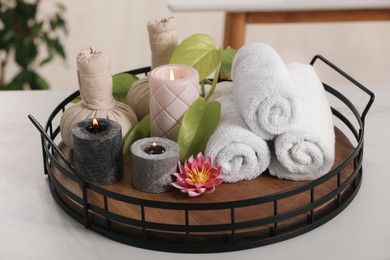 Photo of Composition with different spa products and burning candles on white table