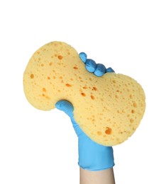 Cleaner in rubber glove holding new yellow sponge on white background, closeup