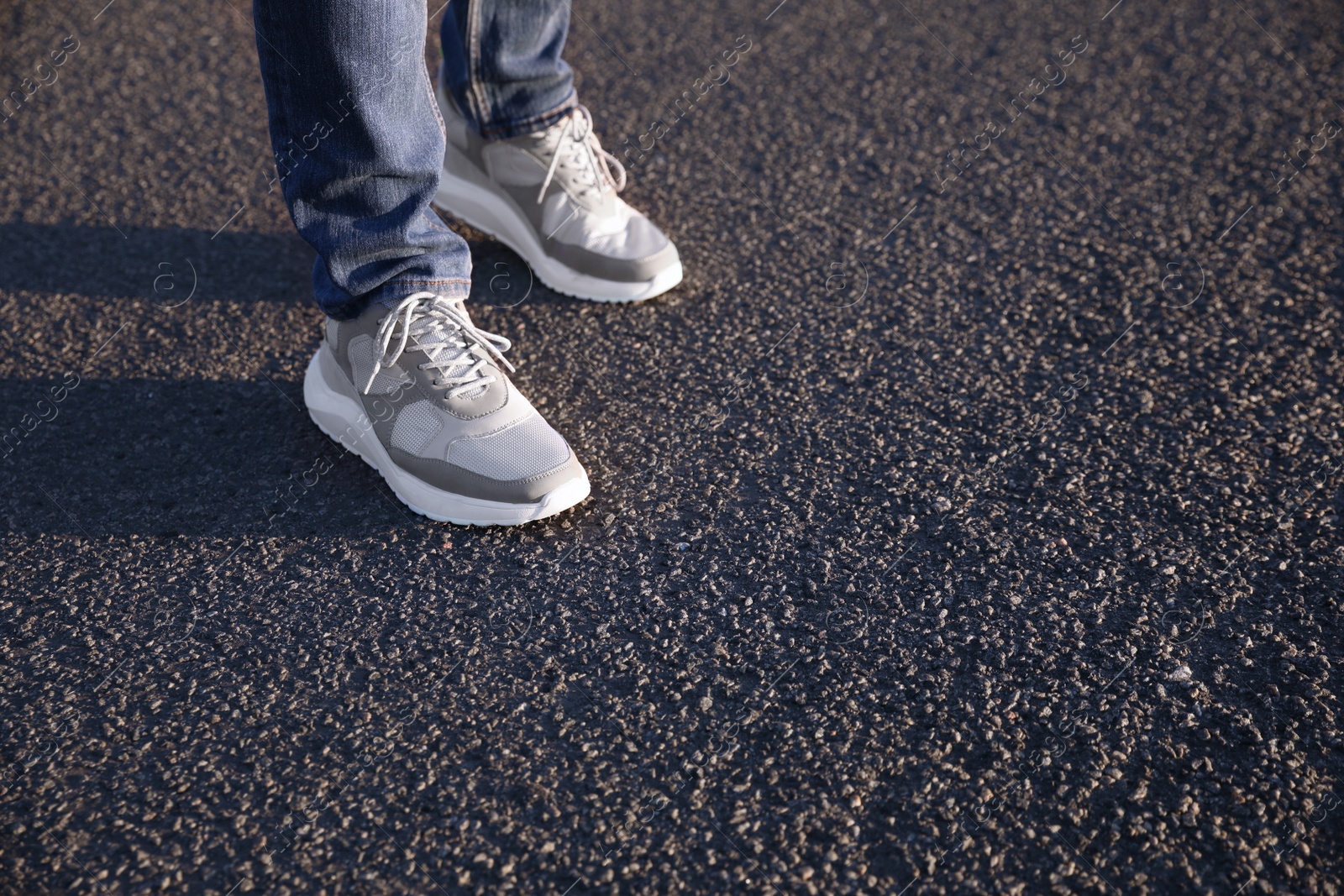 Photo of Man standing on road, closeup with space for text. Choosing way concept