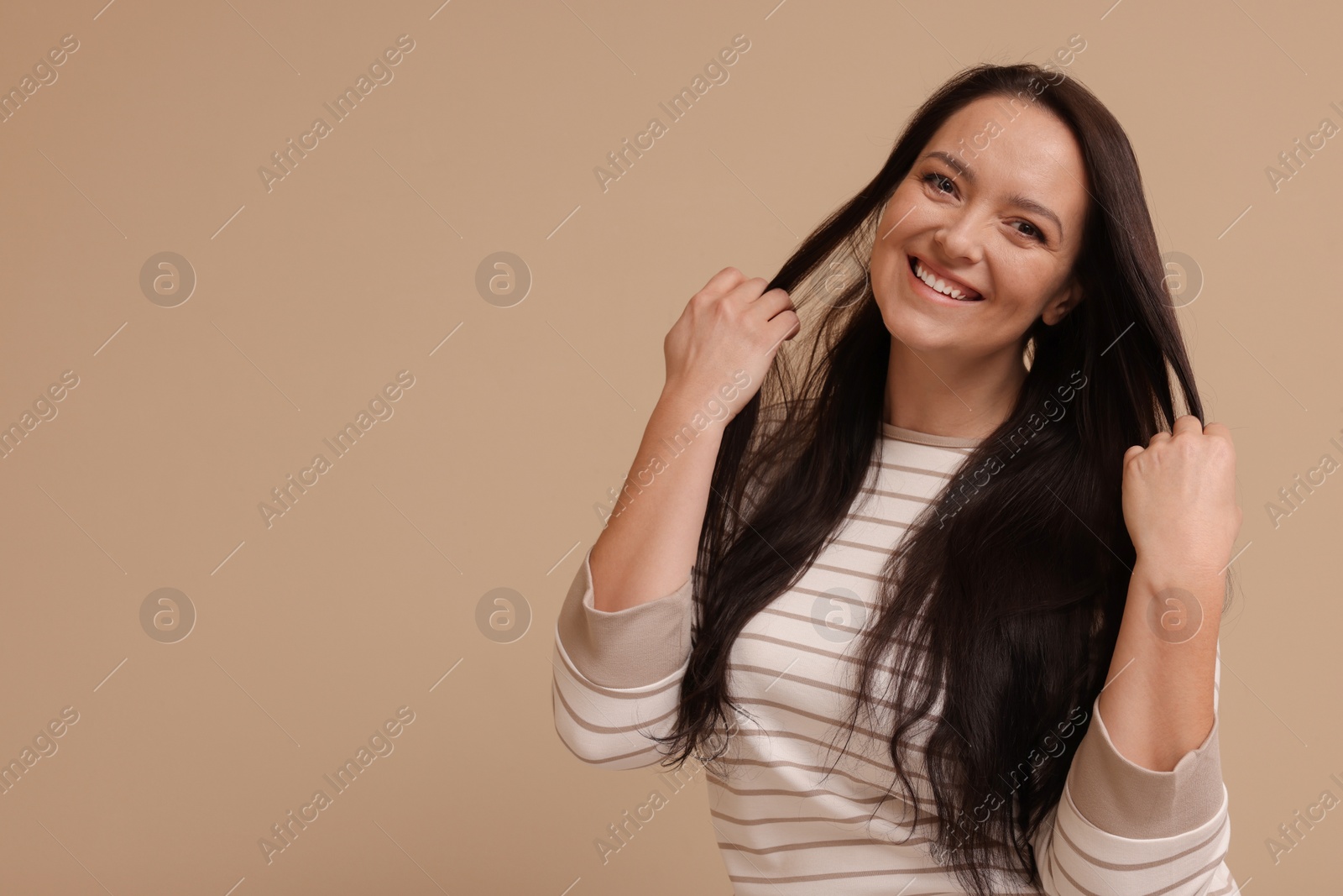 Photo of Beautiful overweight woman with charming smile on beige background. Space for text