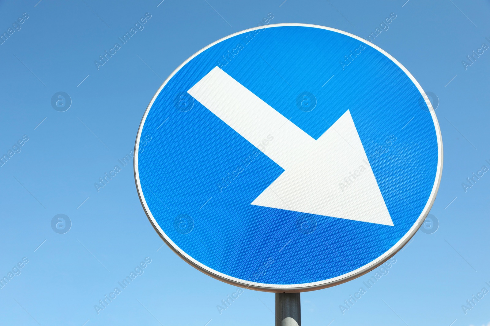 Photo of Traffic sign Keep Right against blue sky, low angle view