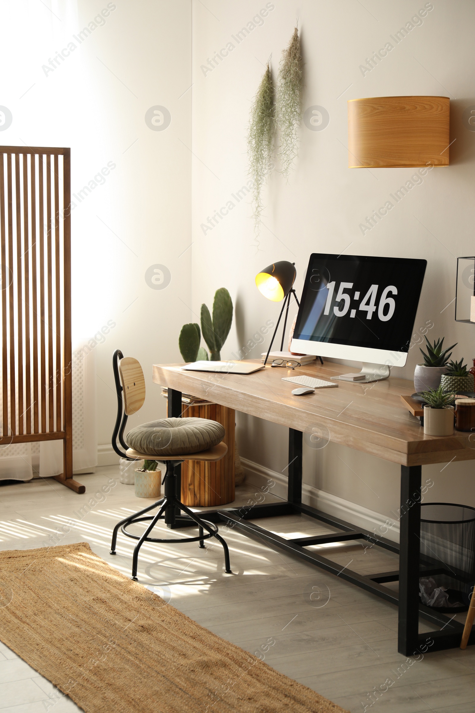 Photo of Room interior with comfortable workplace. Modern computer on wooden desk