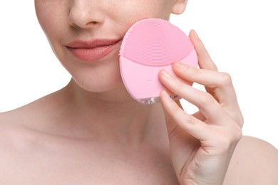 Photo of Washing face. Young woman with cleansing brush on white background, closeup