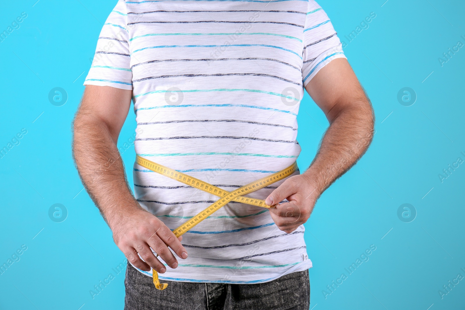 Photo of Fat man with measuring tape on color background, closeup. Weight loss