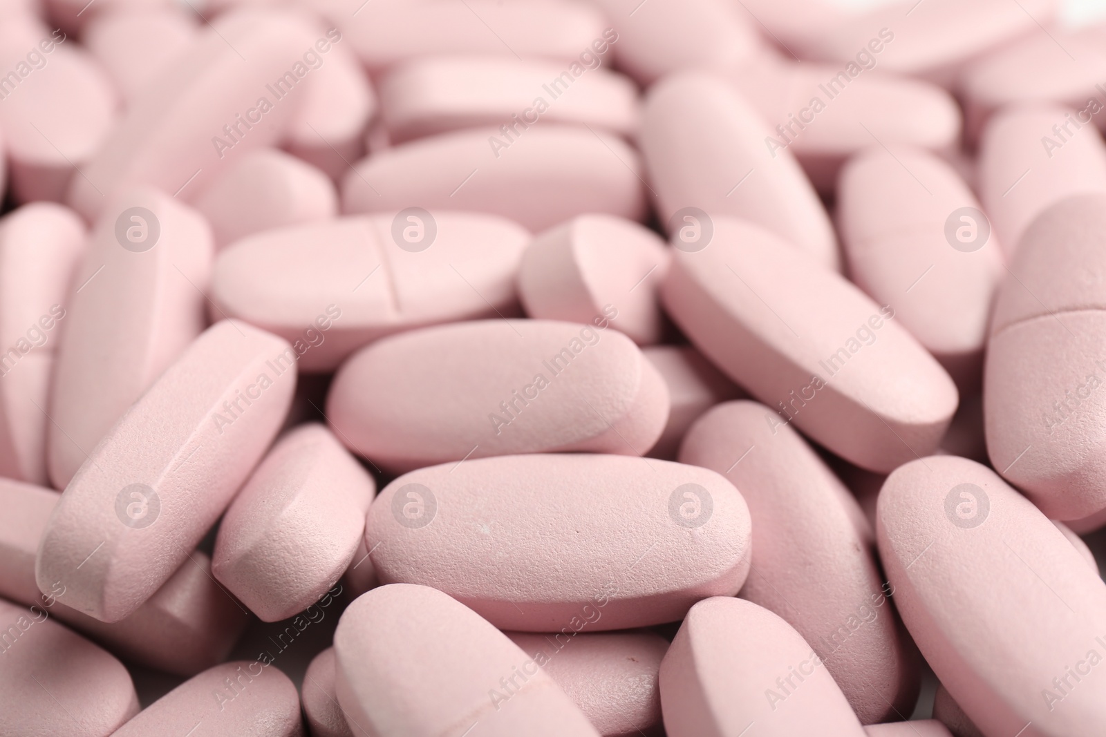 Photo of Many pink vitamin capsules as background, closeup