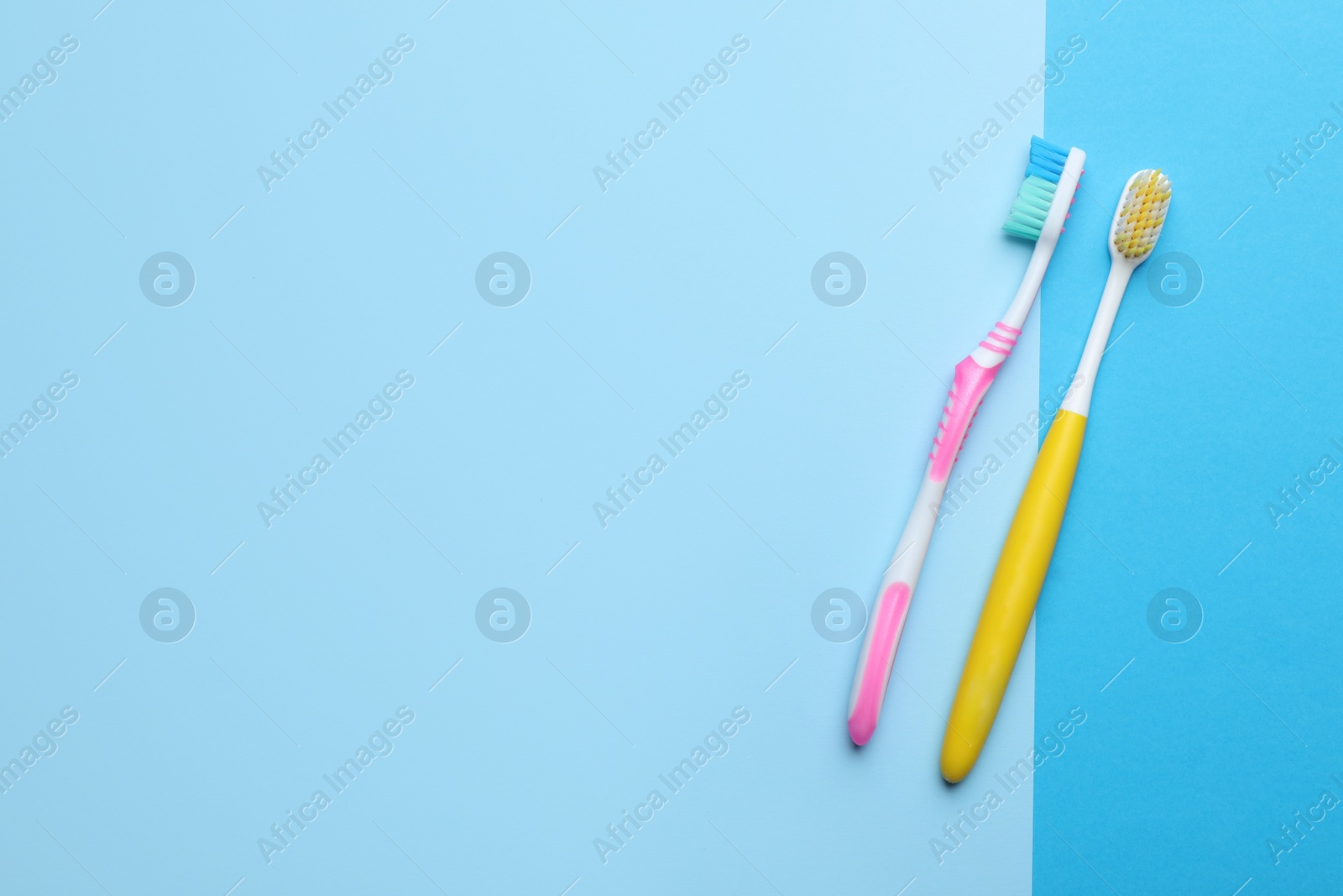 Photo of Toothbrushes on color background, flat lay. Space for text