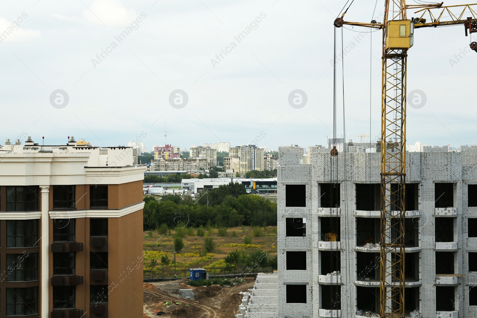 Photo of Construction site with tower crane near unfinished building
