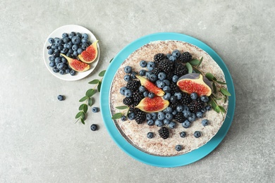 Delicious homemade cake with fresh berries on table, top view