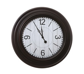 Photo of Stylish wall clock showing five minutes until midnight on white background. New Year countdown