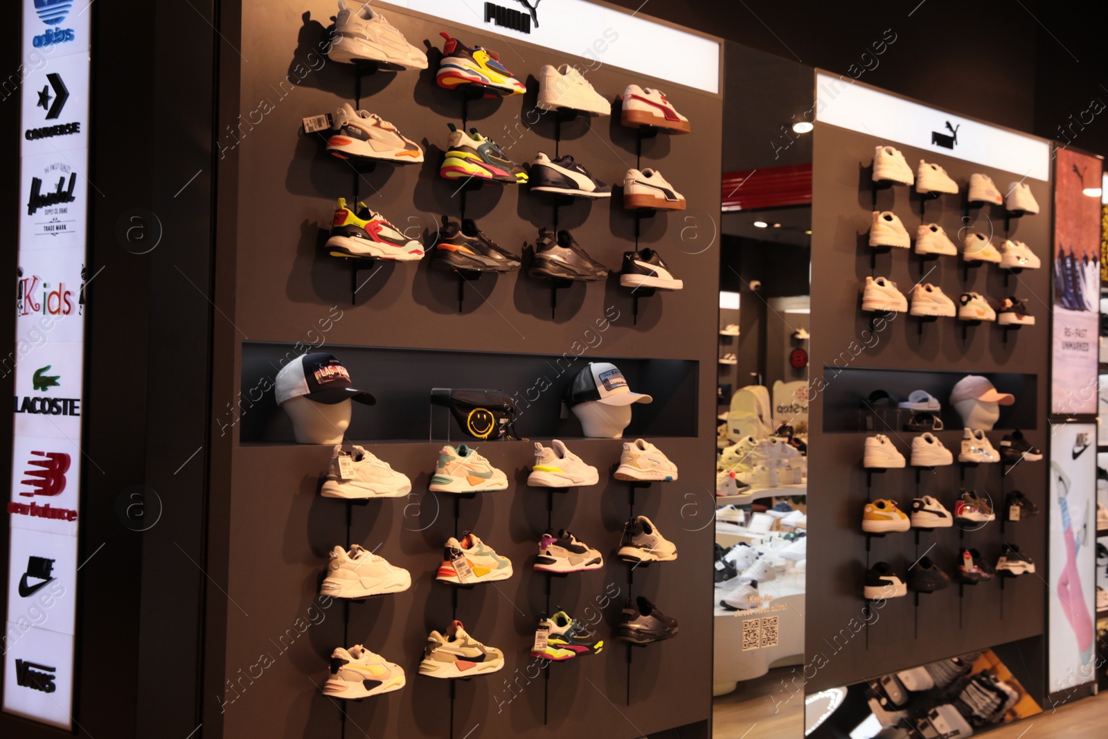 Photo of Turkey, Trabzon-June 30, 2022: Showcase with different sneakers from Puma brand in multibrand shop