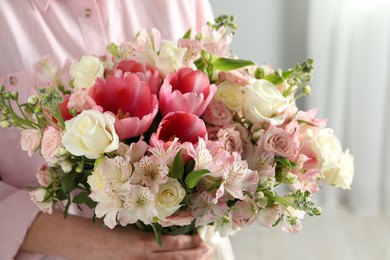 Photo of Woman with beautiful bouquet of fresh flowers indoors, closeup