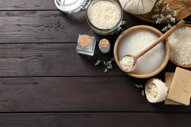 Flat lay composition with soaked rice on wooden table. Space for text